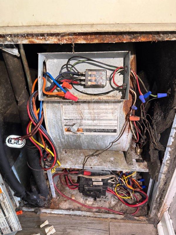 Completed installation of new relay on HVAC system located in outdoor/semi-exposed enclosure. Replaced failed relay component and secured all electrical connections including red, blue, orange, yellow, and black wiring with appropriate wire nuts. System tested and verified operational upon completion.