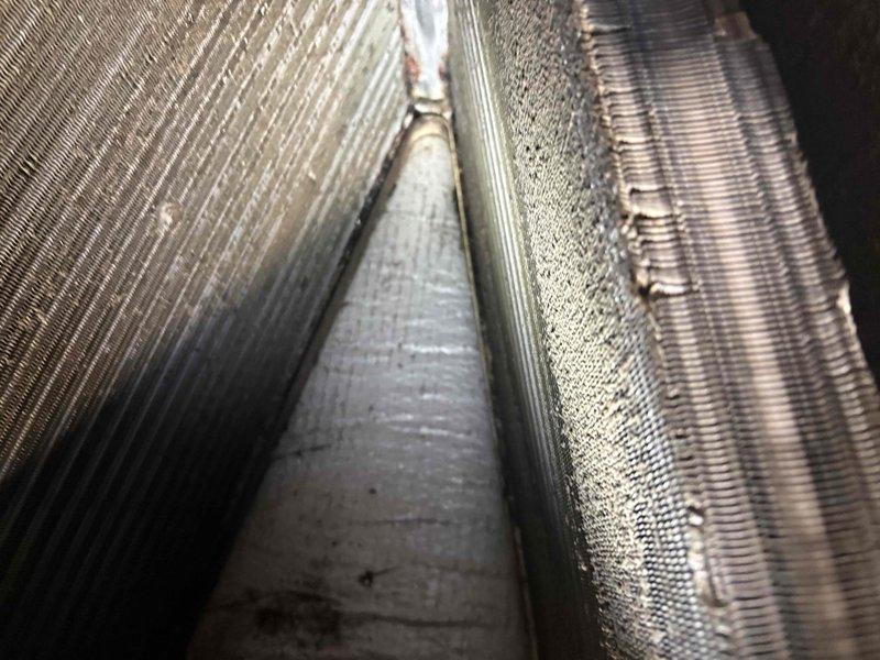 Responded to after-hours dispatch for Lennox system experiencing short cycling with 5-minute run cycles. Upon inspection, found evaporator coil heavily loaded with dust and debris accumulation despite recent condenser cleaning. Documented coil condition showing substantial blockage restricting airflow, which was causing premature shutdown on safety controls. Advised customer that thorough coil cleaning and system evaluation would be required to restore proper operation and resolve short cycling issue.