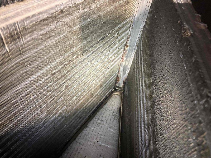Responded to after-hours dispatch for Lennox system experiencing short cycling with 5-minute run cycles. Upon inspection, found evaporator coil heavily loaded with dust and debris accumulation despite recent condenser cleaning. Documented coil condition showing substantial blockage restricting airflow, which was causing premature shutdown on safety controls. Advised customer that thorough coil cleaning and system evaluation would be required to restore proper operation and resolve short cycling issue.