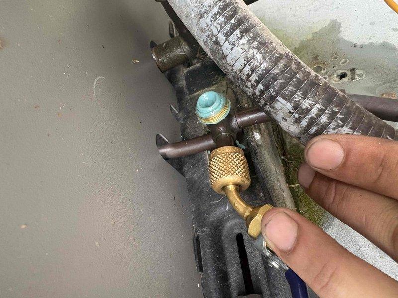 Responded to after-hours dispatch for a 5-year-old HVAC system reported to be running continuously without reaching setpoint temperature. Upon arrival, performed visual inspection of outdoor unit and refrigerant line connections. Documented significant corrosion and oxidation present on copper tubing, service valves, and refrigerant line fittings, with visible turquoise-green patina indicating prolonged exposure to outdoor elements and potential refrigerant leak points. Service port connections showed weathering and deterioration consistent with age and environmental exposure. Captured photographic documentation of corroded brass fittings, deteriorated refrigerant lines, and heavily oxidized components for further evaluation and repair recommendations.