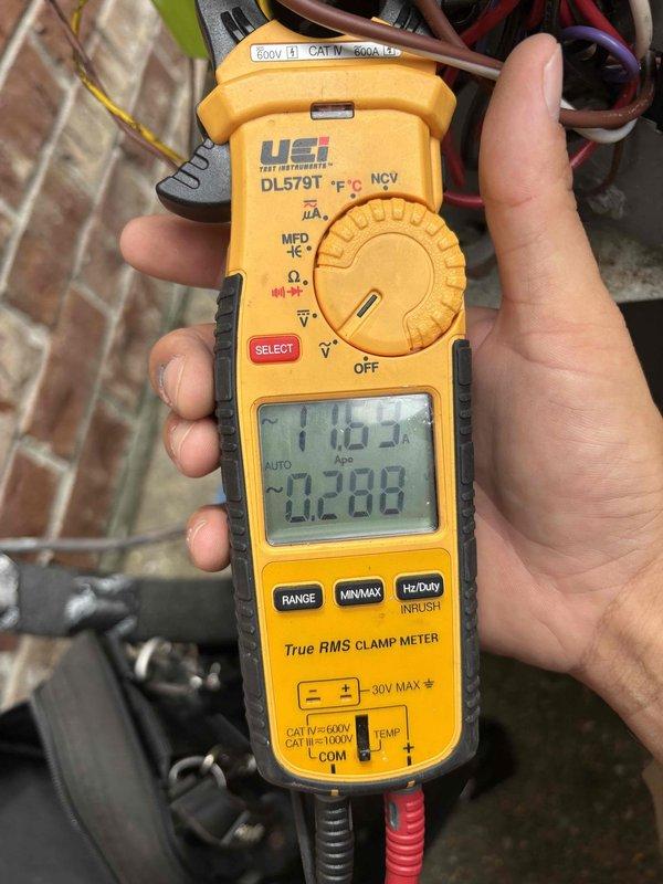 Responded to after-hours service call for non-operational condenser unit with no cooling. Upon arrival, accessed outdoor condensing unit and performed electrical diagnostics using clamp meter. Measured voltage and amperage at contactor, recording 103V and 0.208A readings, indicating potential low voltage or failed component issue. Inspected attic space and ductwork system to verify airflow and check for any related mechanical issues. Found flexible metallic ductwork properly secured with supports and insulation intact. Identified electrical supply issue preventing condactor engagement and condenser operation. Restored system operation and verified proper cooling function before departure.