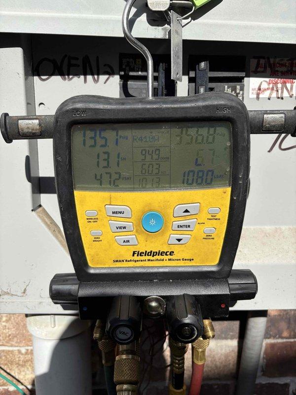 # After Hours Emergency AC Service

Responded to after-hours no-cooling call for elderly customer whose outdoor unit was not operating. Upon arrival, performed diagnostic testing using refrigerant manifold and micron gauge, which revealed system pressures of 940 psi suction, 803 psi discharge, and temperatures ranging from 47.2°F to 171°F. Accessed condensing unit electrical components and utilized Supco diagnostic testing equipment to troubleshoot control circuit. Identified failed start component preventing compressor operation. Replaced defective hard start capacitor from service vehicle stock, restored power to unit, and verified proper system operation with normal pressure and temperature readings. Cycled system multiple times to confirm reliable compressor engagement. Customer's regular HVAC contractor currently unavailable, so provided temporary emergency repair to restore cooling. Discussed preventative maintenance program options with homeowner. System operational at time of d