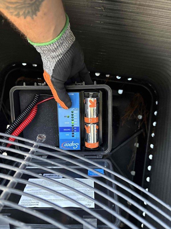 # After Hours Emergency AC Service

Responded to after-hours no-cooling call for elderly customer whose outdoor unit was not operating. Upon arrival, performed diagnostic testing using refrigerant manifold and micron gauge, which revealed system pressures of 940 psi suction, 803 psi discharge, and temperatures ranging from 47.2°F to 171°F. Accessed condensing unit electrical components and utilized Supco diagnostic testing equipment to troubleshoot control circuit. Identified failed start component preventing compressor operation. Replaced defective hard start capacitor from service vehicle stock, restored power to unit, and verified proper system operation with normal pressure and temperature readings. Cycled system multiple times to confirm reliable compressor engagement. Customer's regular HVAC contractor currently unavailable, so provided temporary emergency repair to restore cooling. Discussed preventative maintenance program options with homeowner. System operational at time of d