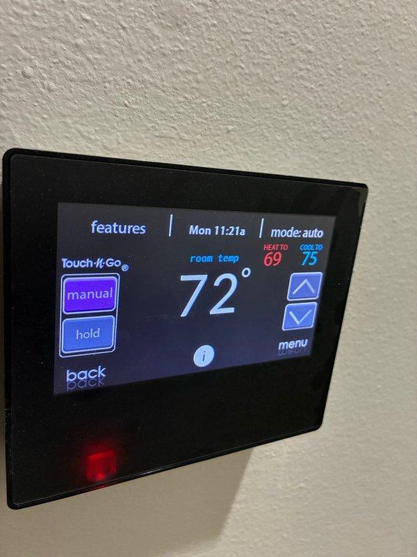Responded to Ion Service Alert indicating serious equipment issue on north end system. Inspected HVAC system and verified thermostat operation showing 72° room temperature with system in auto mode, heating setpoint at 69° and cooling setpoint at 75°. Located and sealed two ductwork connections in attic space as previously identified, applying proper insulation wrap to corrugated flex duct joints to prevent air leakage and maintain system efficiency.