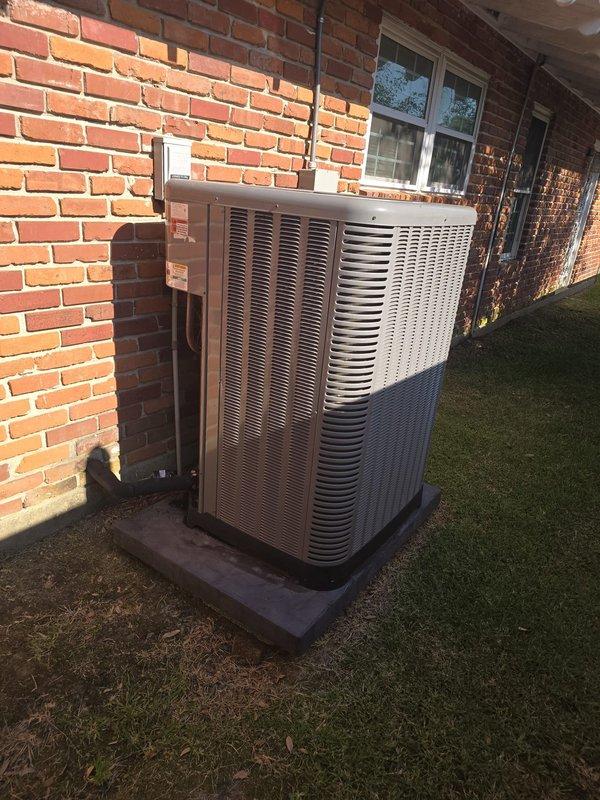 Completed full HVAC system installation including new outdoor condenser unit, evaporator coil, and associated ductwork. Positioned condenser on concrete pad adjacent to building exterior with proper electrical disconnect and refrigerant line connections. Installed new evaporator coil in attic space with supply plenum transition and metal ductwork components. Ran copper refrigerant lines with insulation between outdoor and indoor units, ensuring proper routing through structure. Verified all connections, tested system operation, and confirmed proper airflow through newly installed ductwork.