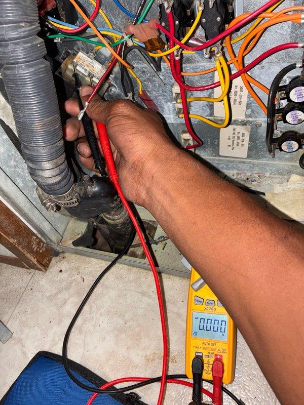 Responded to no-cooling call where air conditioning system failed to operate after thermostat battery replacement. Upon arrival, performed comprehensive system diagnostics using multimeter to test electrical components and connections at the air handler. Inspected blower assembly and found accumulated dust and debris on wheel and housing. Verified proper voltage supply, tested capacitor functionality, and checked all control circuit wiring connections. Documented system condition with photos showing blower wheel contamination and electrical testing procedures for quality assurance and customer records.