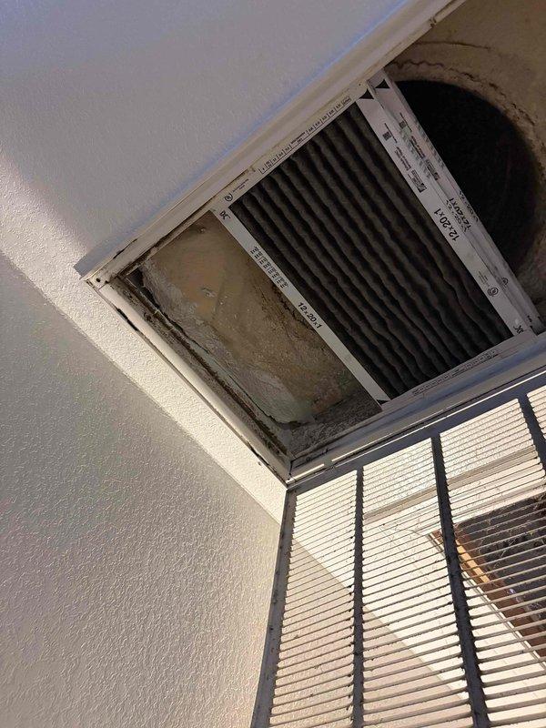 Responded to service call for zoned HVAC system with reversed damper operation on 5-ton unit. Inspected two-zone damper configuration and return air vents, documenting existing installation with poor accessibility and deteriorated ceiling conditions around vent openings. Customer reported issue present since home purchase three years ago with four previous companies unable to resolve damper reversal problem without recommending full system replacement. Assessed damper wiring and zone control board connections to determine if simple rewiring could correct reversed operation versus requiring damper replacement or system modification.