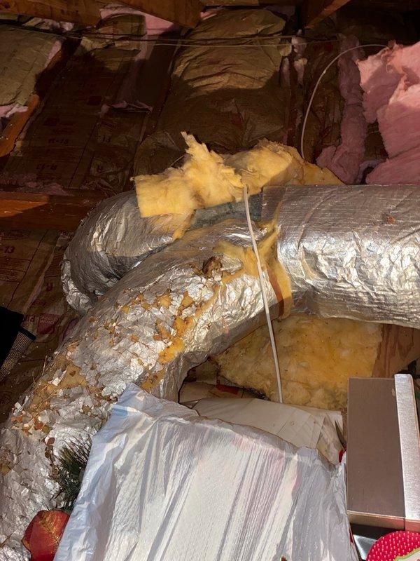 Responded to service call for 20-year-old AC system not cooling and producing humming noise while blowing warm air. Performed comprehensive system inspection including attic ductwork evaluation and outdoor condenser unit diagnostics. Utilized clamp meter and manifold gauge set to test electrical amperage and refrigerant pressures. Found compromised flexible ductwork in attic with deteriorated outer layer and disturbed insulation. Tested condenser unit functionality and electrical components. Documented system conditions and presented customer with repair versus replacement options based on unit age and current performance issues.