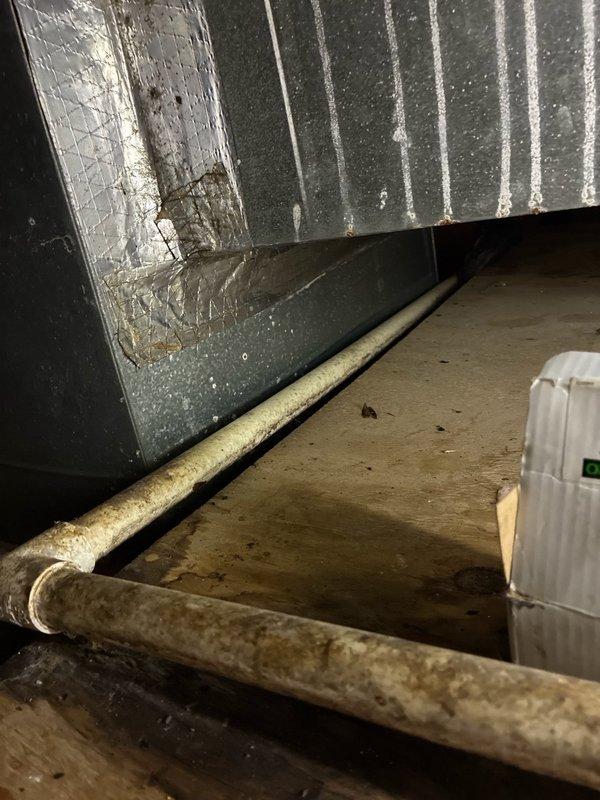 Responded to no cooling call with outdoor unit not operating. Upon arrival, found system with no refrigerant charge. Inspection revealed severely corroded refrigerant lines in attic space showing extensive rust and deterioration from moisture exposure. Lines exhibited significant oxidation and compromised integrity, indicating long-term leak condition resulting in complete refrigerant loss. Documented existing conditions with photos showing deteriorated piping and surrounding HVAC infrastructure. System requires refrigerant line replacement before charging and restoring operation.