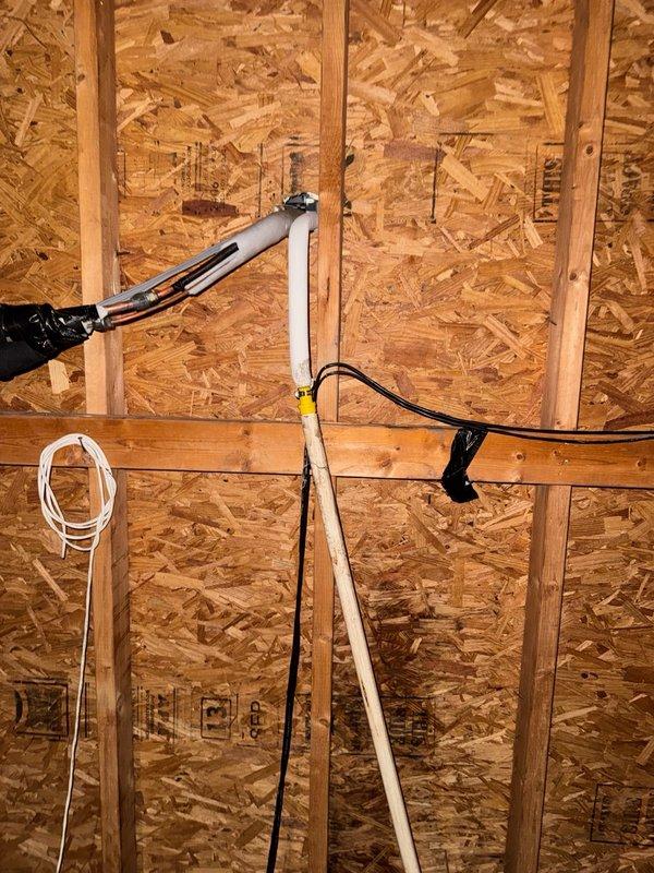 Responded to water leak complaint from attic-mounted mini split system serving game room. Upon inspection, identified condensate drainage issue causing water intrusion and damage to interior wall. Documented existing plumbing installation including PVC drain lines, refrigerant line set with insulation, and electrical wiring. Assessed condensate management system and wall damage extent. Photographed rough-in plumbing work, framing, and HVAC installation for documentation and further remediation planning.