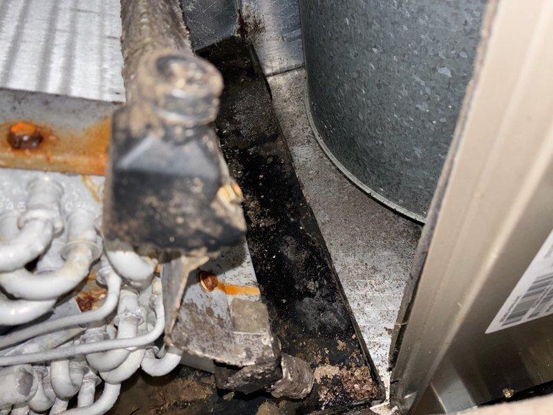 Responded to no cooling call with thermostat reading 82 degrees. Upon arrival, performed system diagnostics using digital manometer to measure static pressures and airflow characteristics. Inspected HVAC equipment and associated ductwork in mechanical space, documenting existing conditions including refrigerant lines, drainage components, and system valves. Customer unable to access attic area to verify drain pan status at time of service. Equipment showed signs of age with visible dust accumulation and wear on components.