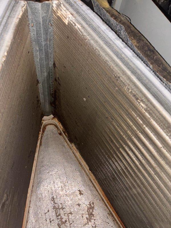 Responded to cooling complaint where system was unable to maintain temperature below 80 degrees and running continuously. Upon inspection, found evaporator coil with significant dirt and debris accumulation affecting heat transfer efficiency. Outdoor condenser unit operational but system performance compromised by restricted airflow through dirty coil. Discussed system sizing concerns with customer and recommended professional coil cleaning to restore proper cooling capacity before evaluating equipment adequacy for home's cooling load.