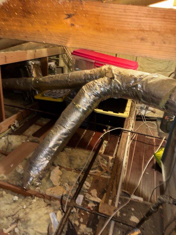 Responded to after-hours service call for HVAC system experiencing intermittent freezing and cycling issues. Upon arrival, accessed attic space and inspected Lennox system components including air handler, ductwork, and refrigerant lines. Observed corroded copper refrigerant line connections showing significant oxidation and deterioration at connection points. Evaluated flexible ductwork routing and condition throughout crawl space, noting dust accumulation and general wear. Assessed electrical connections and control box operation. Documented equipment condition and system configuration with photographs for service records. System evaluated for potential refrigerant leak at corroded pipe connections and cycling control issues requiring further diagnosis or follow-up service.