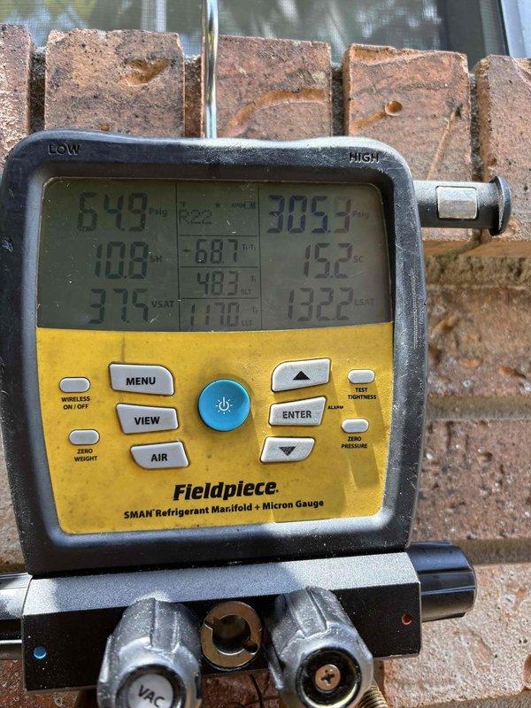 Responded to dispatch for cooling system not maintaining setpoint with 13-degree temperature differential. Connected manifold gauges and performed comprehensive system diagnostics including refrigerant pressure and temperature readings on both high and low sides. Previous service visit included leak dye injection requiring follow-up leak search. Utilized digital manifold to measure system performance parameters and assess refrigerant charge levels to determine if system leak has resulted in low refrigerant condition affecting cooling capacity.