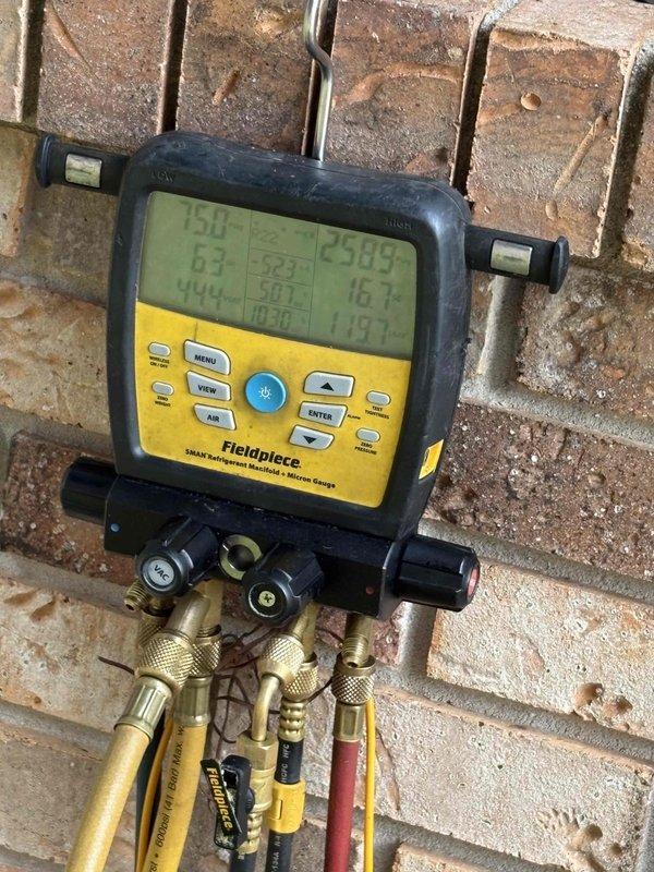 Responded to dispatch for cooling system not maintaining setpoint with 13-degree temperature differential. Connected manifold gauges and performed comprehensive system diagnostics including refrigerant pressure and temperature readings on both high and low sides. Previous service visit included leak dye injection requiring follow-up leak search. Utilized digital manifold to measure system performance parameters and assess refrigerant charge levels to determine if system leak has resulted in low refrigerant condition affecting cooling capacity.