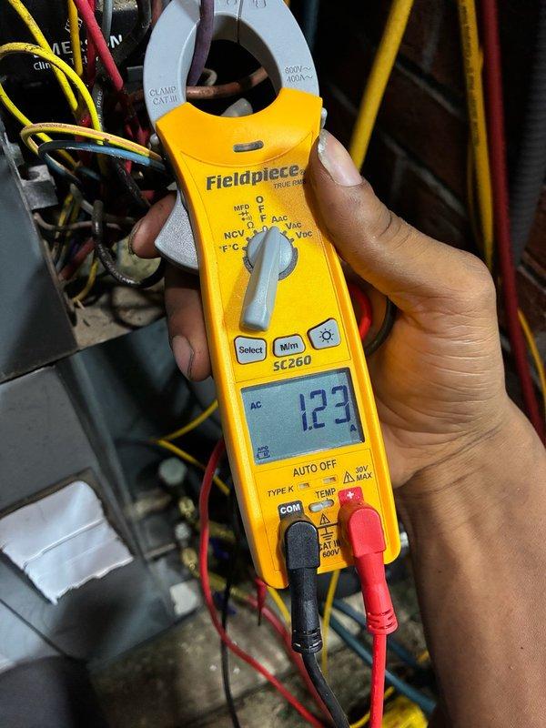 Responded to cooling complaint on dual-system property where units were not reaching setpoint of 70°F and only cooling to 72°F. Diagnosed failed capacitor on affected system using Fieldpiece SC260 clamp meter to verify electrical readings. Replaced defective capacitor with new TRADE PRO unit, reconnected all electrical terminals, and verified proper amperage draw of 123 amps. System tested and confirmed operational with proper cooling cycle restored.