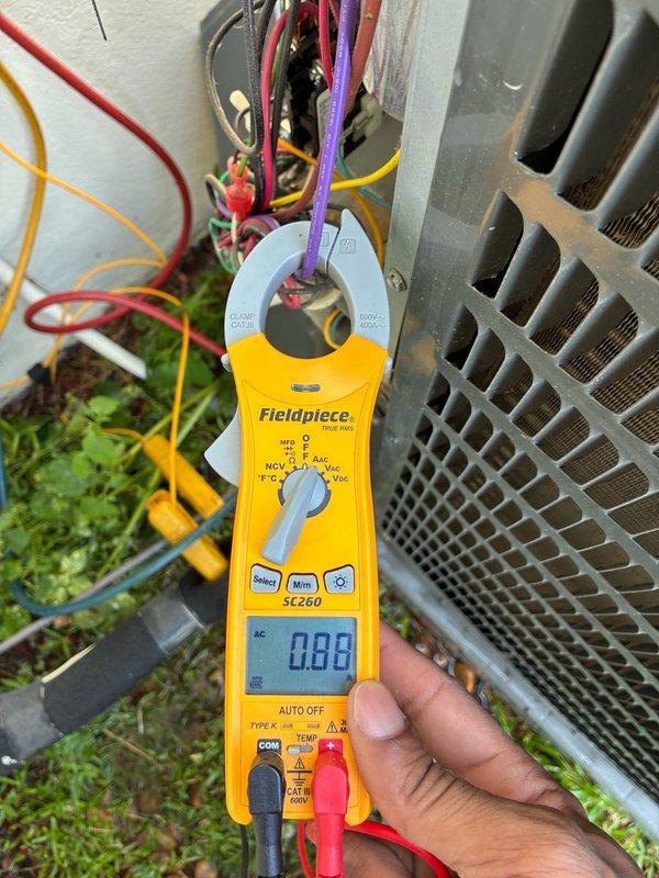 Responded to no cooling complaint for main living area system in residence with three HVAC systems. Performed diagnostic evaluation using clamp meter to test electrical components and verify power supply to outdoor condensing unit. Inspected attic-mounted air handler and associated ductwork connections. Homeowner had no historical maintenance records or system information available as property was recently acquired. Documented equipment conditions with photos for service records.