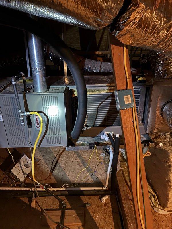 Responded to no cooling complaint for main living area system in residence with three HVAC systems. Performed diagnostic evaluation using clamp meter to test electrical components and verify power supply to outdoor condensing unit. Inspected attic-mounted air handler and associated ductwork connections. Homeowner had no historical maintenance records or system information available as property was recently acquired. Documented equipment conditions with photos for service records.