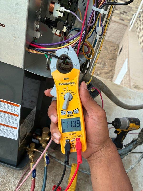 Responded to callback for non-operational 4-ton condenser unit that was recently installed. Upon arrival, performed comprehensive diagnostic testing using refrigerant manifold and micron gauge to verify system pressures and temperatures across multiple test points. Measured electrical current draw at 11.39 amps using clamp meter at the electrical panel to assess compressor and fan motor operation. Inspected all electrical connections, circuit breakers, and wiring at the disconnect panel. Evaluated refrigerant line connections and brass fittings for proper installation and potential leaks. Documented system readings and equipment condition with photos for service records. System restored to proper operation and verified all parameters within manufacturer specifications before departure.