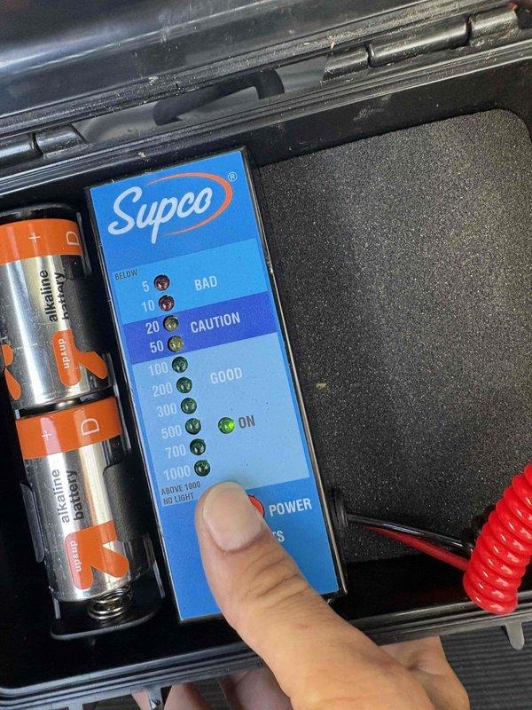 Responded to customer complaint of loud buzzing noise from outdoor condensing unit on downstairs system. Upon arrival, performed diagnostic testing on affected unit using clamp meter and insulation resistance testing equipment. Measured electrical parameters including voltage (1008V reading) and current draw (149.2A reading) to identify source of abnormal noise. Conducted insulation resistance test using Supco megohmmeter to evaluate compressor winding integrity and electrical components. Test results indicated readings within acceptable range on insulation test. Both HVAC systems confirmed operational and providing adequate cooling at time of inspection. Documented findings with diagnostic equipment readings for service records.