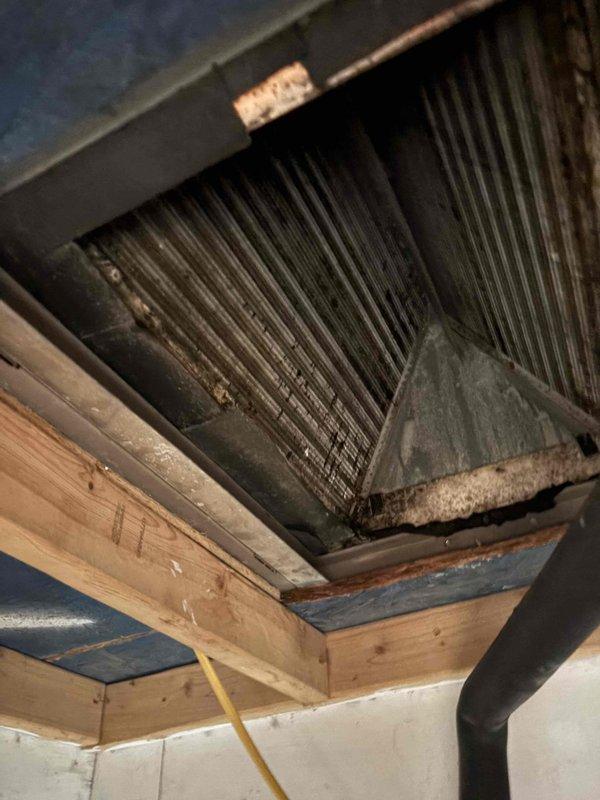 Responded to no cooling complaint with reported dripping noises and suspected drain pan issue. Upon arrival, inspected HVAC system and evaporator coil assembly. Found condensate drainage concern requiring attention. Documented system condition with photos showing air handler, coil fins, and surrounding work area. Verified no active water damage to ceiling at time of inspection.