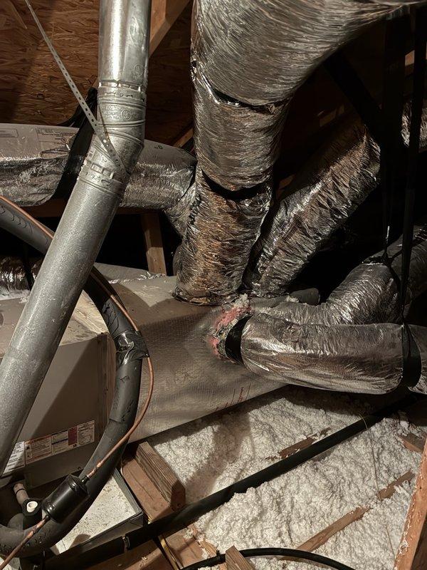 Responded to service call for HVAC system blowing warm air. Due to customer mobility limitations preventing attic access, advised system be turned off with fan left in circulation mode until technician arrival. Accessed attic space and documented existing air handler installation and flexible ductwork configuration. System reported to be out of warranty with unknown installation date.