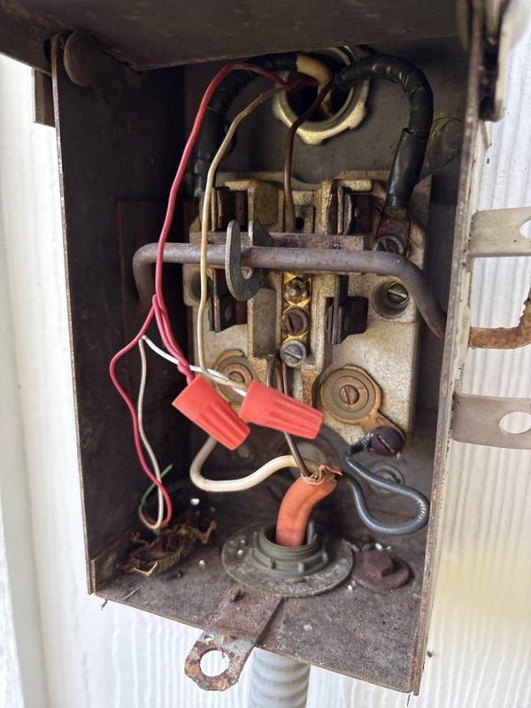 Responded to no cooling call where condenser unit was not operating. Upon arrival, found aged outdoor disconnect switch with heavily corroded contacts and deteriorated wiring connections. Tested system pressures using digital manifold gauges, which revealed suction pressure of 64 psi and discharge pressure of 232.9 psi with subcooling at 26.5°F and superheat at 4.1°F. Inspected electrical connections at disconnect and documented condition of outdoor equipment. Customer advised of findings and provided recommendations for necessary repairs to restore system operation.