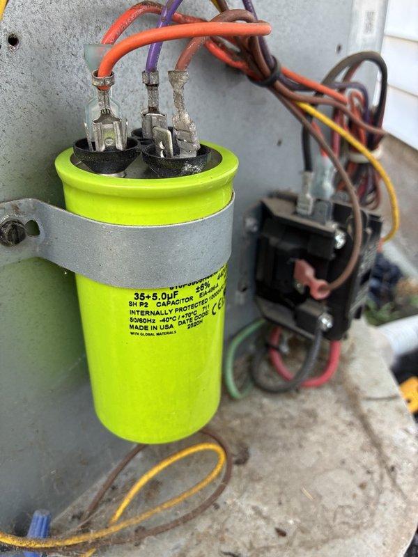 Responded to no cooling call on downstairs system. Upon arrival, accessed outdoor condensing unit and performed electrical diagnostics using clamp meter to test voltage and amperage at contactor and capacitor terminals. Inspected dual-run capacitor rated at 35+5 MFD, 370 VAC with connections to compressor and condenser fan motor. Verified thermostat set point at 70 degrees with rising indoor temperature. Conducted complete system evaluation and tested all electrical components to diagnose cooling failure.
