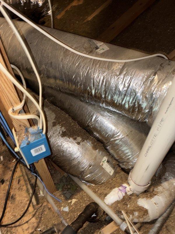 Performed comprehensive tune-up and inspection on an 18-month-old electric air conditioning system with primary concern of drain pan filling every 12 hours. Inspected attic-mounted air handler unit, examined flexible ductwork insulation integrity, and assessed condensate drainage system including PVC drain lines and fittings. Evaluated system operation, verified proper airflow through supply ducts, and checked for potential drainage blockages causing pan overflow condition.