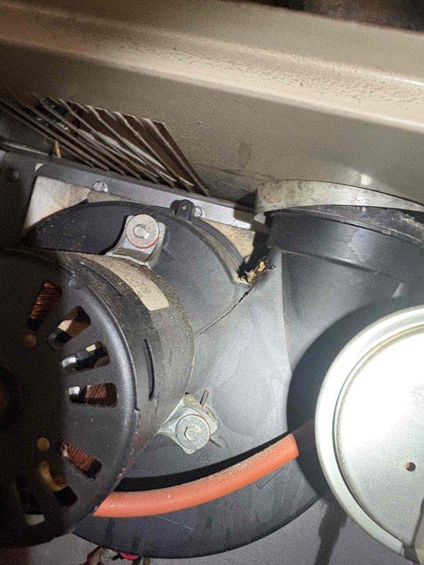 Responded to service call for HVAC system evaluation. Customer reported possible refrigerant leak in attic air handler from previous technician visit approximately one year ago. Performed visual inspection of aging air handler unit and blower motor assembly. Documented existing equipment condition with photos showing significant dust accumulation, age-related deterioration, and staining on interior surfaces. Assessed blower motor, copper refrigerant lines, and overall cabinet condition. Provided customer's authorized decision-maker with repair versus replacement options for the air handler unit, noting the condenser is relatively new at only a few years old while the air handler shows considerable age and wear.