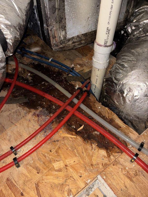Received call regarding water leaking from attic HVAC unit. Consultation provided over phone due to customer declining immediate dispatch service. Advised customer to power down system to prevent further water damage and utilize fans for ventilation in affected attic space. Recommended using shop vacuum to extract standing water and check condensate drain pan for overflow condition. Photos documented visible condensation on air handler cabinet and attic mechanical space showing PVC drain lines, flexible ductwork, and OSB flooring with potential water exposure. Customer opted to perform initial assessment of drain pan status before scheduling on-site service visit.