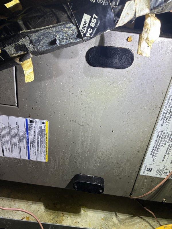 Received call regarding water leaking from attic HVAC unit. Consultation provided over phone due to customer declining immediate dispatch service. Advised customer to power down system to prevent further water damage and utilize fans for ventilation in affected attic space. Recommended using shop vacuum to extract standing water and check condensate drain pan for overflow condition. Photos documented visible condensation on air handler cabinet and attic mechanical space showing PVC drain lines, flexible ductwork, and OSB flooring with potential water exposure. Customer opted to perform initial assessment of drain pan status before scheduling on-site service visit.