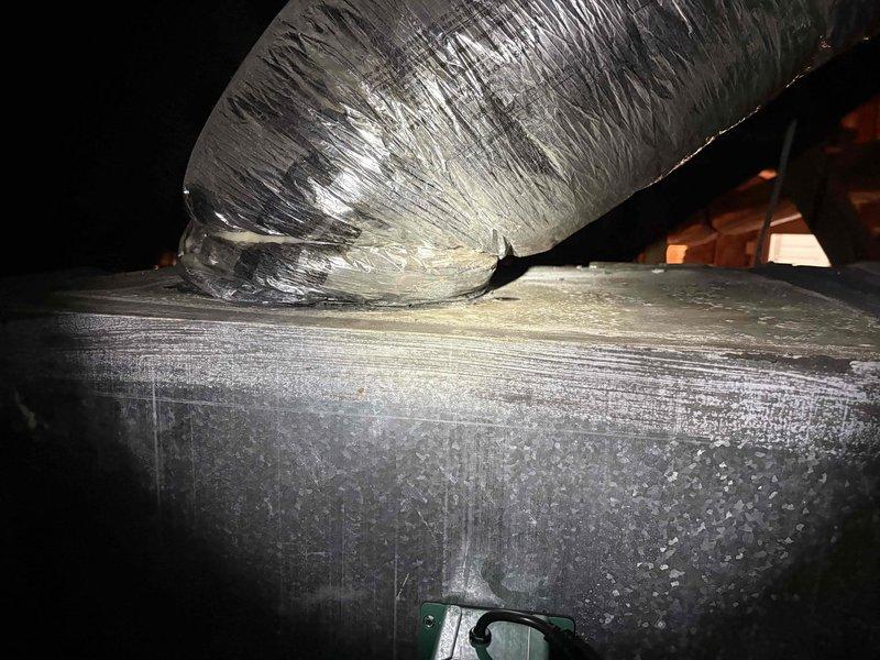 Responded to dispatch regarding condensation issues on ductwork following recent plenum and air handler replacement. Upon inspection in attic space, confirmed visible moisture accumulation and sweating on metal ductwork components affecting kitchen, living room, and master bathroom areas. Documented extensive condensation on rectangular plenum and rigid ductwork sections with photographic evidence showing crystalline moisture buildup on metallic surfaces. Assessed flexible duct connections and identified inadequate insulation as contributing factor to temperature differential causing condensation formation.