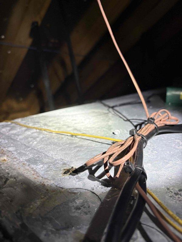 Responded to dispatch regarding condensation issues on ductwork following recent plenum and air handler replacement. Upon inspection in attic space, confirmed visible moisture accumulation and sweating on metal ductwork components affecting kitchen, living room, and master bathroom areas. Documented extensive condensation on rectangular plenum and rigid ductwork sections with photographic evidence showing crystalline moisture buildup on metallic surfaces. Assessed flexible duct connections and identified inadequate insulation as contributing factor to temperature differential causing condensation formation.