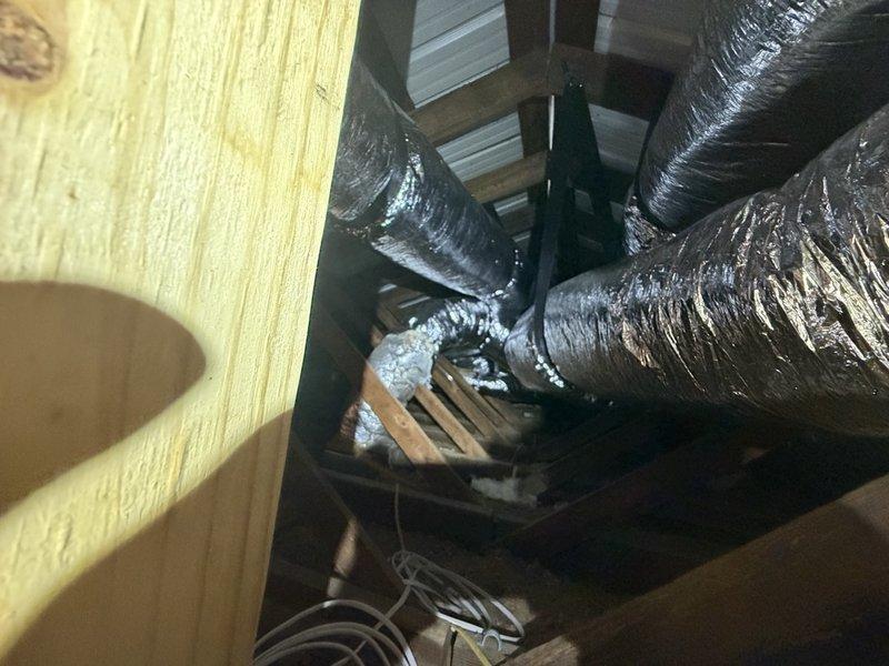 Completed installation of 4-ton side discharge HVAC system with full ductwork over a two-day period. Navigated attic space through side access, exercising caution around overhead power lines as noted in site conditions. Routed flexible insulated ductwork through existing attic structural framework, connecting multiple trunk and branch lines to ensure proper air distribution throughout the residence. Installation included cutting access points in attic flooring as needed and securing all ductwork to wooden framing members per code requirements. All ductwork properly insulated and sealed at connection points to maximize system efficiency and minimize air leakage.