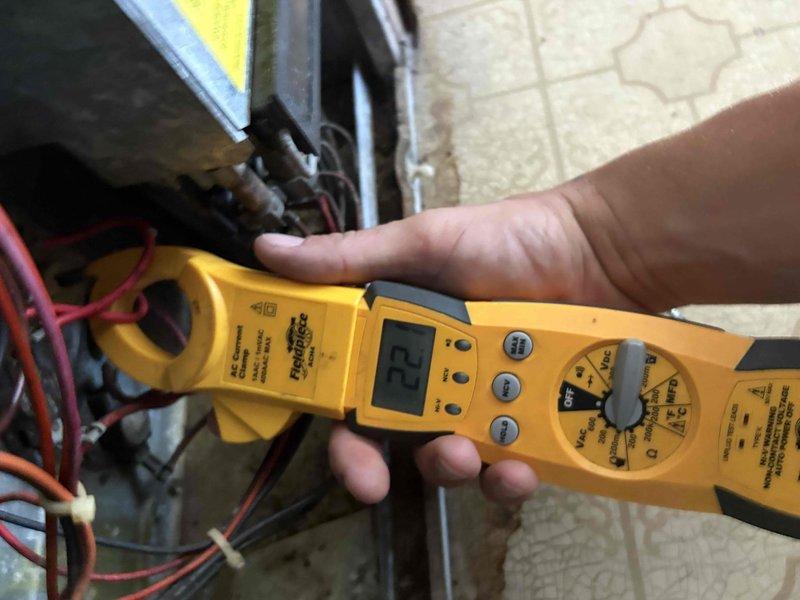 Completed fall maintenance tune-up on single heating system in residential utility space. Performed comprehensive inspection of furnace unit, tested electrical components using clamp meter with voltage readings within normal operating parameters at 23V, verified all control wiring connections secure, and confirmed proper system operation. Unit showed age-appropriate wear with dust accumulation cleaned during service visit.