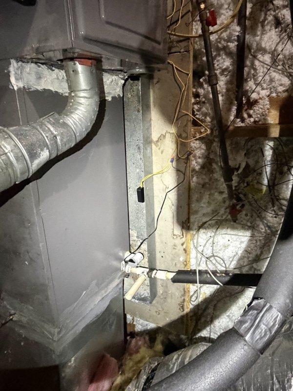 Installed pan safety switch at indoor air handler unit to provide secondary drain line protection and prevent water damage from potential condensate overflow. Sealed return air ductwork connections to eliminate air leakage and improve system efficiency. Replaced failed 45 MFD dual run capacitor at outdoor condensing unit to restore proper compressor and condenser fan motor operation. Verified all electrical connections secure, tested system operation through complete cooling cycle, and confirmed proper airflow and temperature differential across evaporator coil.
