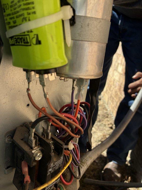 Responded to no cooling call on HVAC unit that was completely non-operational. Customer reported unit had been running approximately one hour before shutting down and indicated recent compressor or condenser replacement by another service provider. Upon arrival, performed visual inspection of electrical components and wiring connections within the equipment cabinet. Examined contactor, relay assembly, and associated wire connections including orange, red, purple, yellow, and black conductors. Utilized Fieldpiece SC260 True RMS multimeter to diagnose electrical issues and verify proper voltage and continuity throughout the system. Documented equipment condition and electrical configuration with photos for service records. System required further electrical troubleshooting to determine root cause of complete unit failure following recent component replacement.