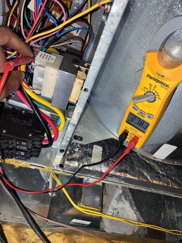 Completed fall tune-up and maintenance on single heating system. Performed comprehensive diagnostic testing using digital multimeter to verify electrical components and system voltage readings at 21.09V. Inspected control panel wiring, connections, and relay components for proper operation. Observed significant condensation on heat exchanger cylinder indicating normal temperature differential during system operation. All electrical connections, terminals, and wiring harnesses verified secure and functioning within manufacturer specifications. System tested and confirmed operational.