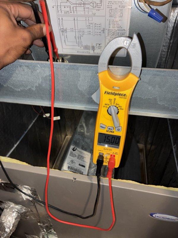 Performed a routine AC tune-up, including electrical testing of the air handler with a clamp meter and inspection of the accessible ductwork and plenum connections. The inspection revealed a torn flexible duct wrap near the plenum take-off, with exposed fiberglass insulation, which should be repaired to prevent air leakage and condensation. The system was operating normally at completion.