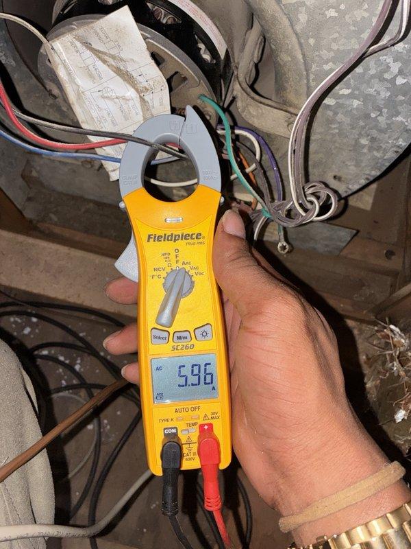 Completed fall heater tune-up on one system, including inspection of the blower compartment, motor, capacitor, and wiring connections. Measured blower motor amperage with a true RMS clamp meter (5.96 A) to verify proper electrical operation, and noted heavy dust and debris buildup on the blower housing and cabinet interior along with an aged, partially torn wiring diagram.