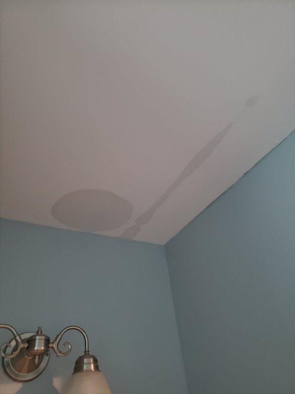 Performed annual heating maintenance and responded to a reported condensate drain line separation that was causing water intrusion into the bathroom. Inspected the primary float switch and condensate drain system, then re-secured the disconnected drain line with black duct strap to restore proper drainage. Documented water staining on the ceiling below the unit from the leak.