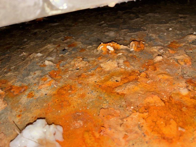 Responded to an after-hours call for an AC system not cooling on a unit installed in 2020. Inspection revealed severe corrosion and rust deterioration on the drain pan and equipment base, with peeling protective coating and mineral buildup, indicating long-term moisture exposure. Findings were documented with photos for further evaluation and repair recommendations.