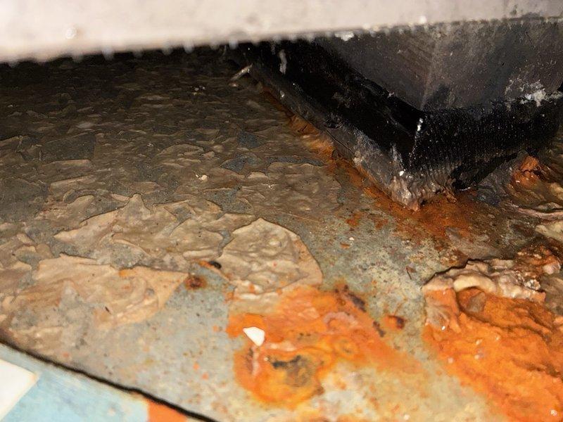 Responded to an after-hours call for an AC system not cooling on a unit installed in 2020. Inspection revealed severe corrosion and rust deterioration on the drain pan and equipment base, with peeling protective coating and mineral buildup, indicating long-term moisture exposure. Findings were documented with photos for further evaluation and repair recommendations.