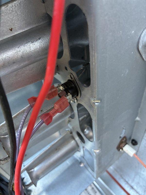 Responded to an after-hours no-heat call on the downstairs gas furnace; unit is out of warranty. Inspected the control circuitry and limit/sensor wiring, and measured amperage on the blower motor circuit with a clamp meter, which read 1.99 A AC. Noted heavy corrosion on the exterior gas supply piping.