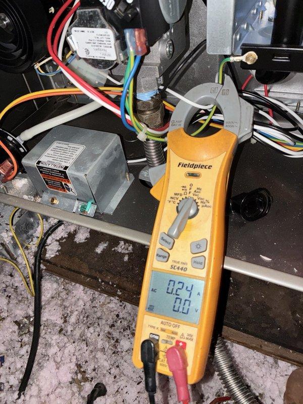 Performed a fall heating tune-up on one system, inspecting the furnace interior and cleaning the blower wheel to remove heavy dust and debris buildup from the fan blades. Measured blower motor amperage with a clamp meter (0.24 A AC) to verify electrical operation, and checked wiring and gas line connections within the cabinet.