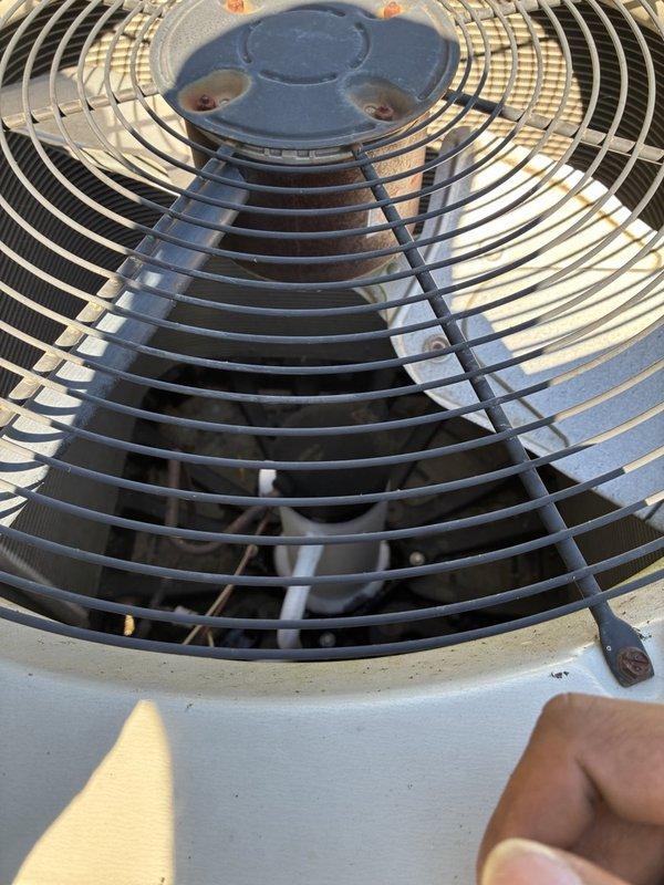 Responded to a no-cool complaint (warm air from supply) and performed a visual inspection of the outdoor condenser unit. Observed corrosion on the condenser fan motor hub and housing fasteners, debris accumulation within the cabinet, and severely deteriorated, cracked suction line insulation at the condensate/service fitting. Advised the customer to shut the system off at the thermostat and run the indoor blower only (fan-only mode) pending further diagnosis and repair.
