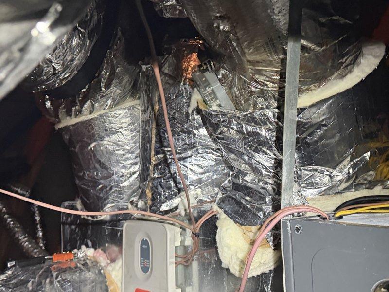 Sealed and insulated all duct collars and the areas surrounding the zone dampers to eliminate condensation and prevent further moisture issues. Repaired torn and damaged foil-faced insulation jackets on the supply ducts and bypass duct, restoring the vapor barrier with sealed insulation wrap.