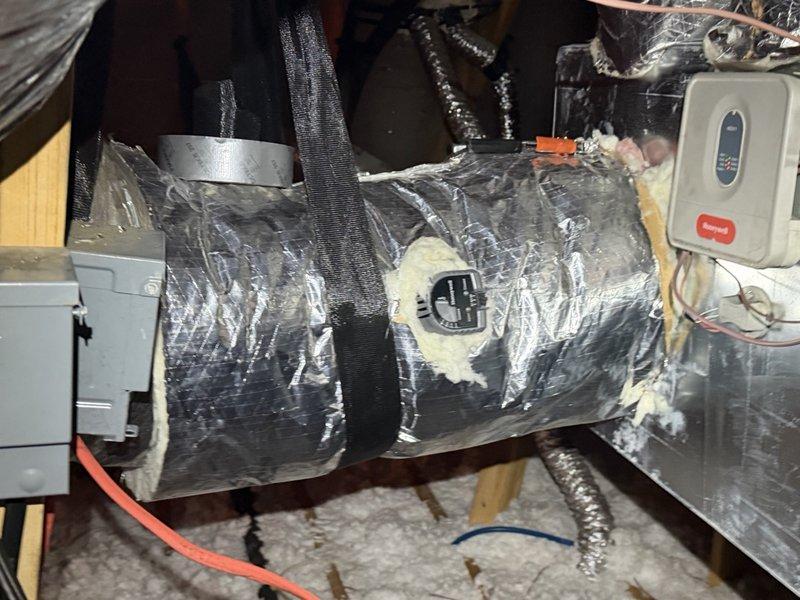 Sealed and insulated all duct collars and the areas surrounding the zone dampers to eliminate condensation and prevent further moisture issues. Repaired torn and damaged foil-faced insulation jackets on the supply ducts and bypass duct, restoring the vapor barrier with sealed insulation wrap.