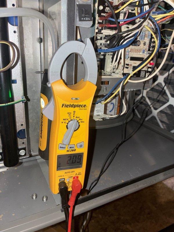 Performed a fall heating tune-up on one system, inspecting the furnace cabinet, control board wiring, and inducer/blower assembly for proper operation. Verified electrical performance with a clamp meter, measuring approximately 2.09 amps on the motor circuit, and observed the motor running smoothly. No signs of rust, frost, or damage were found, and the system was left operating normally.